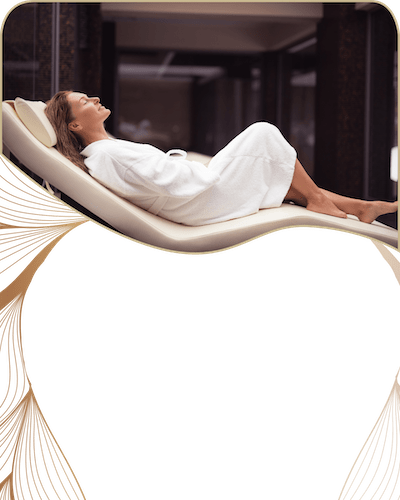 Woman lying down in a spa bed wearing a white robe