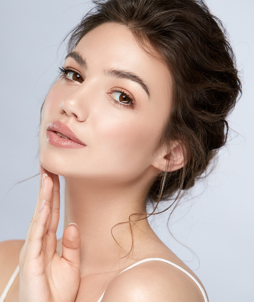Woman with her fingertips against her chin.