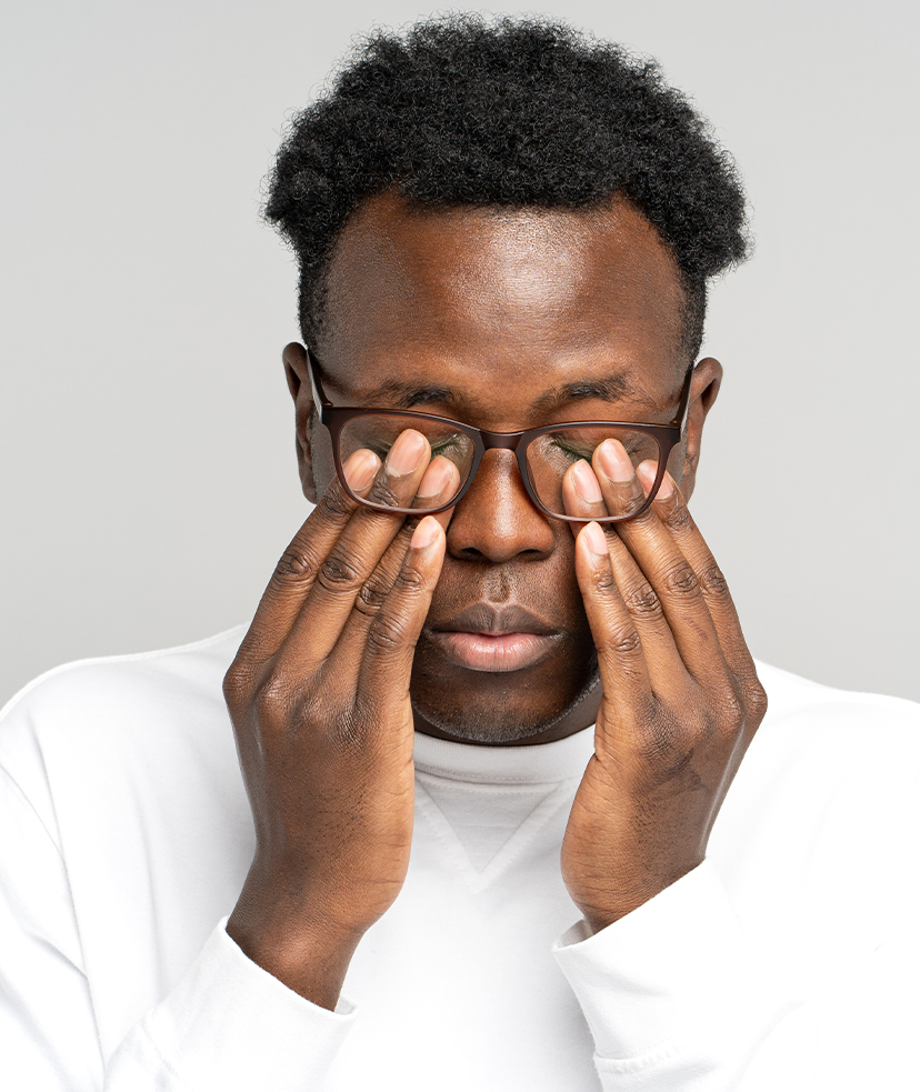 Fatigued man rubbing his eyes.