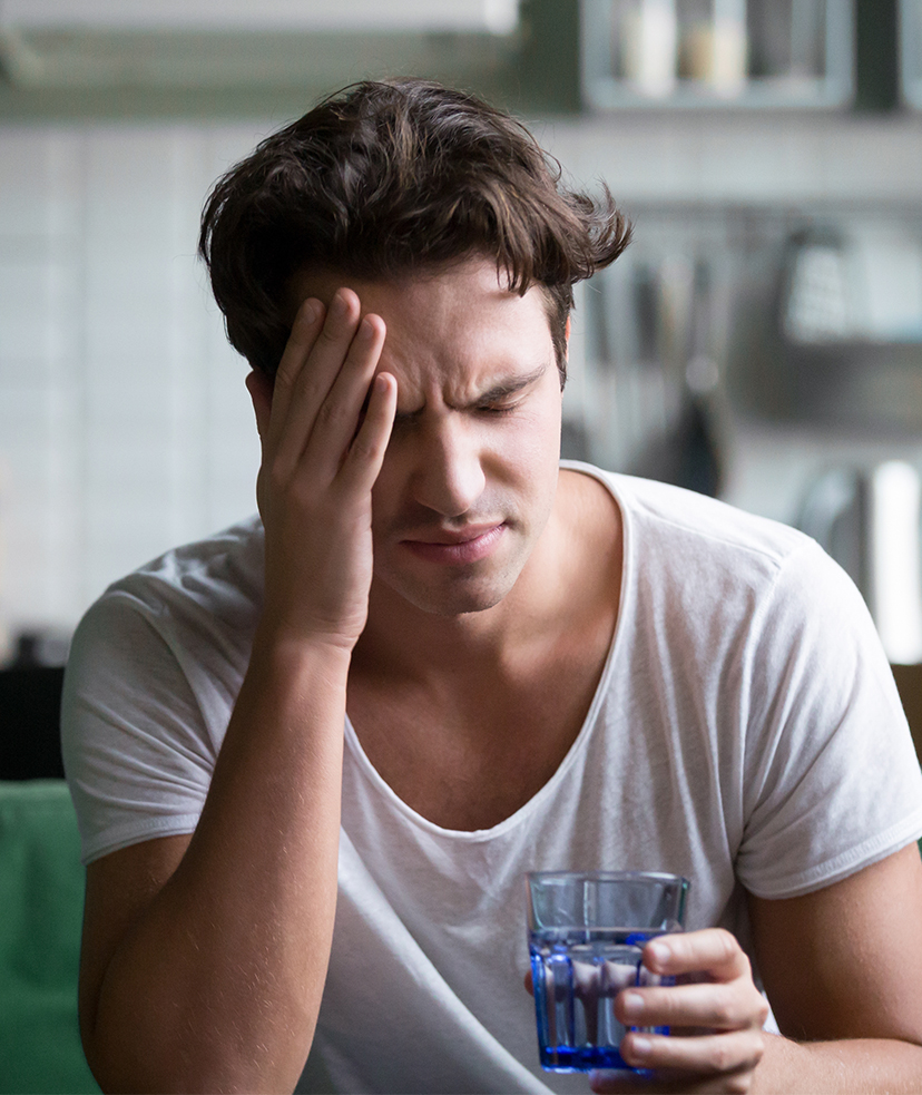 Man struggling with a hangover.