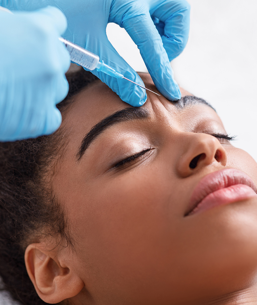 Woman getting an injection in her forehead.