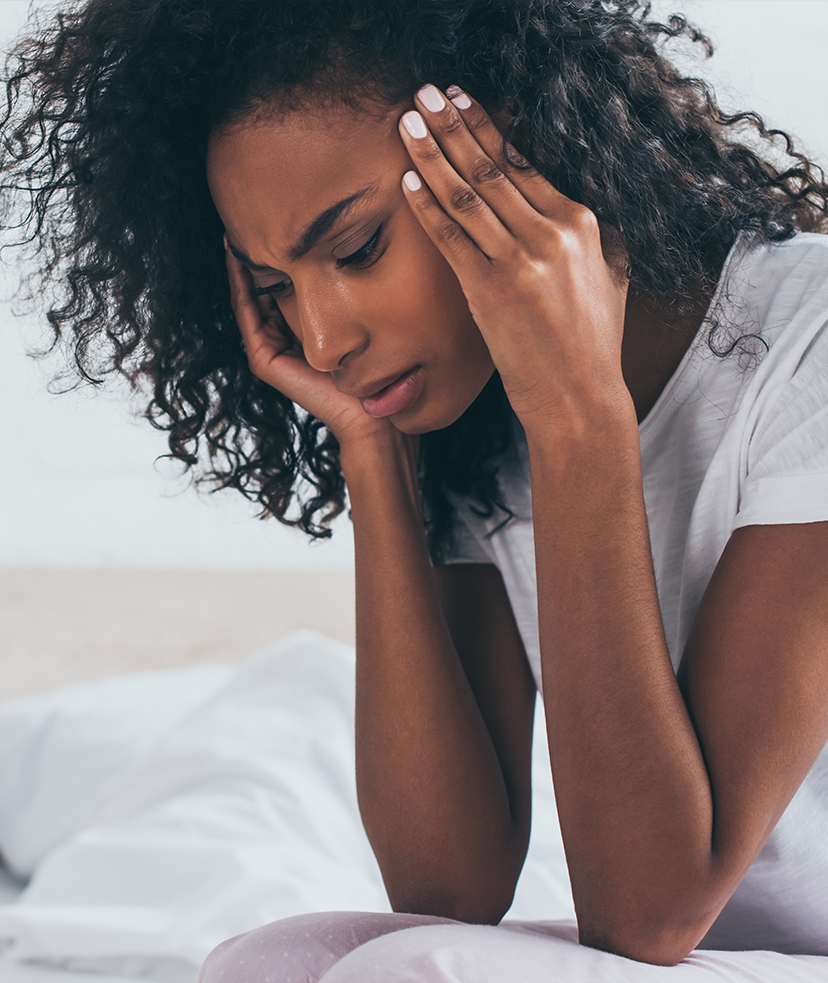 Woman struggling with a migraine.