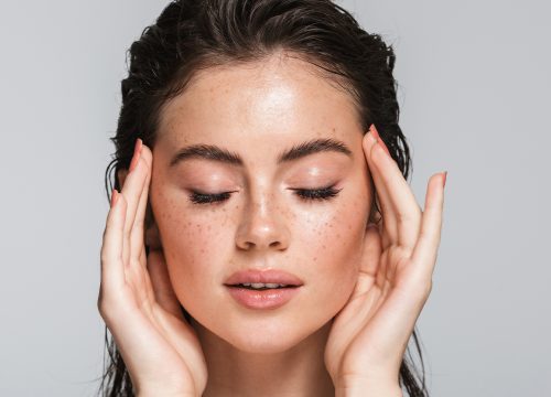Woman with her hands on her face.