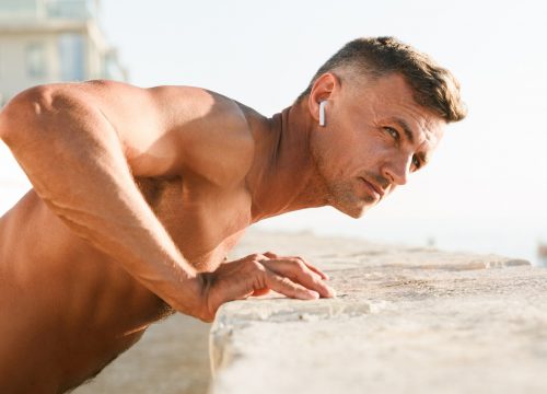 Photo of a man doing push-ups on top of a building
