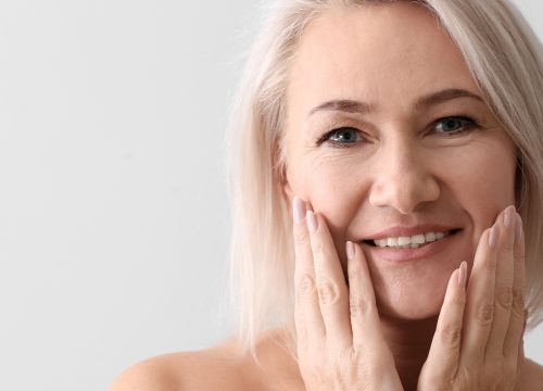 Woman with her hands on her face.